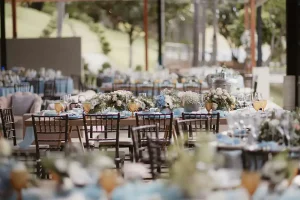 an outdoor all-inclusive wedding venue with dining table set pieces, dishes, and decor